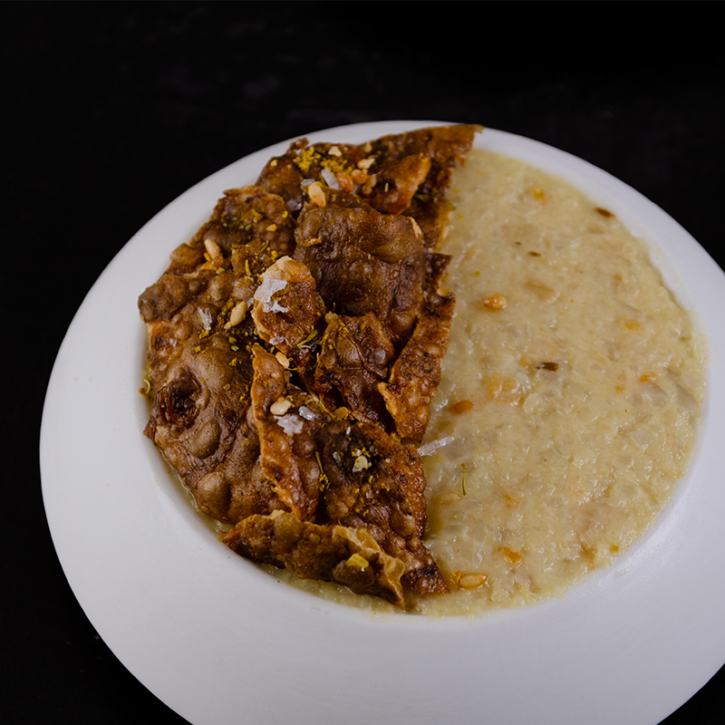 Jerusalem Artichoke Spread topped with artichoke crisps served in a white round bowl