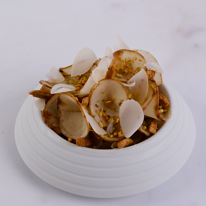 Thin slices of pickled artichoke garnished with spice of angels, honey caramelised sesame seeds and sliced Avola almonds