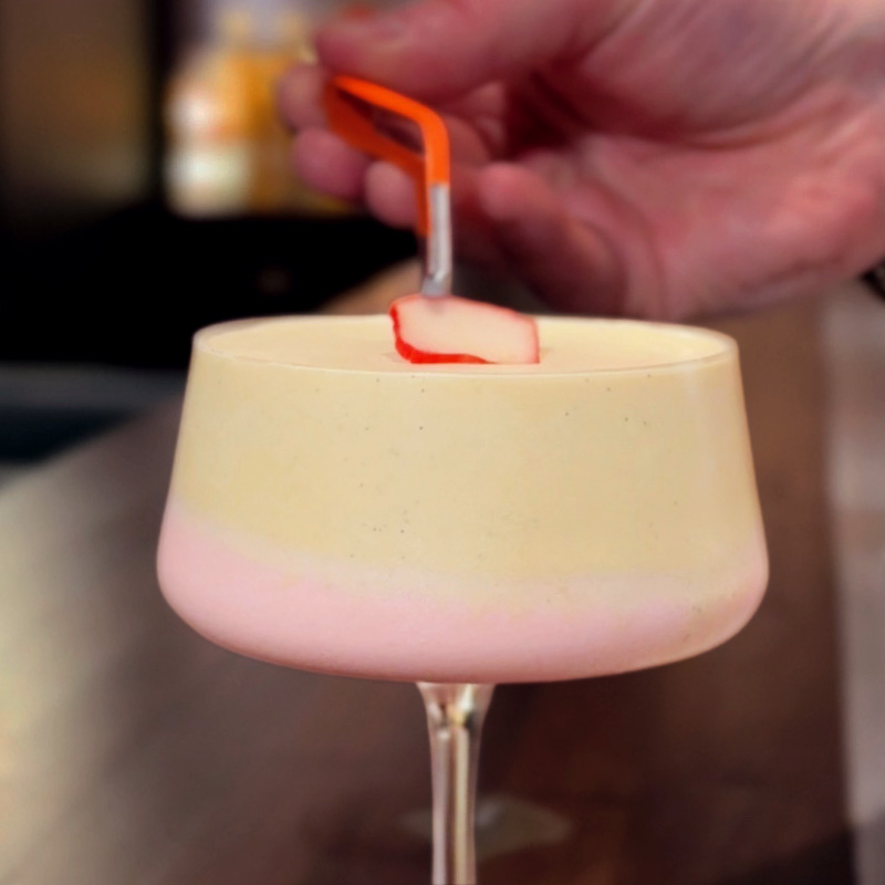 Rhubarb and Custard Slush Garnish A picture of the rhubarb and custard slush served in a glass being garnished