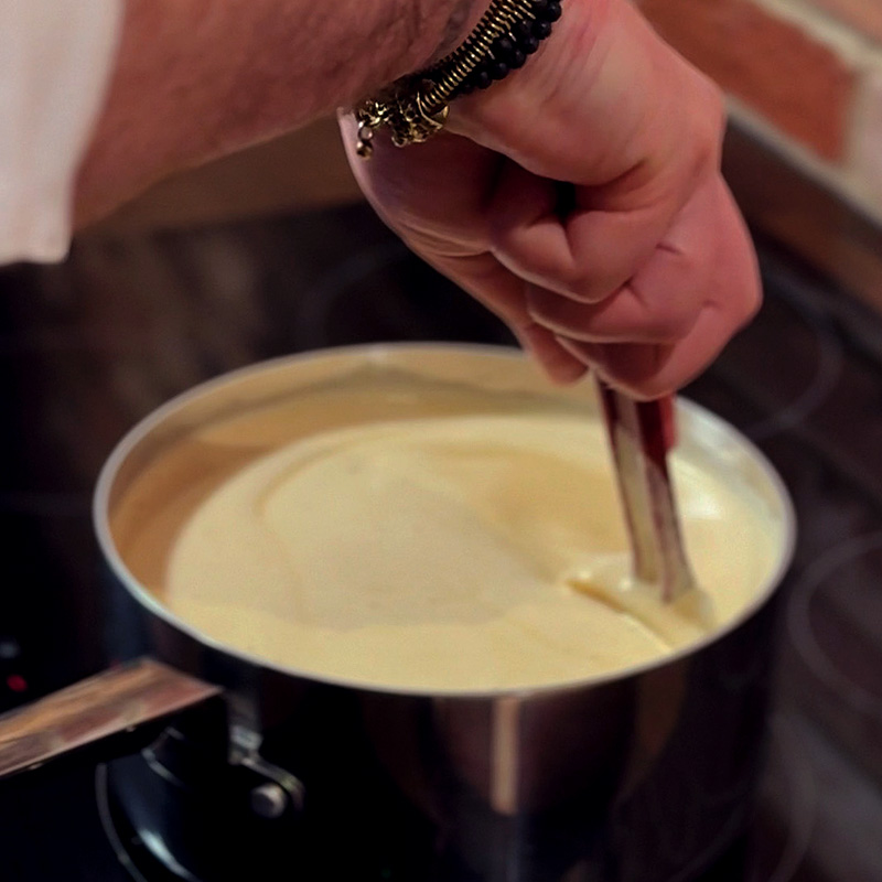 Vanilla Custard Stir Vanilla custard in a pan being stirred
